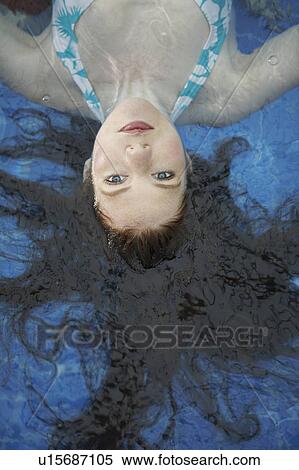 Portrait of a woman floating in a pool. View Large Photo Image Stock Photography - Portrait of a woman floating in a pool.. Fotosearch