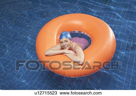 Stock Image - Portrait of woman in a rubber ring.. Fotosearch