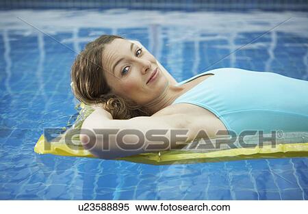 Portrait of woman lying on a lylo. View Large Photo Image Stock Photography - Portrait of woman lying on a lylo.. Fotosearch