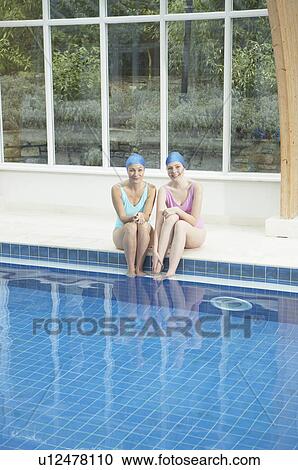 Two woman by edge of swimming pool. View Large Photo Image Stock Image - Two woman by edge of swimming pool.. Fotosearch