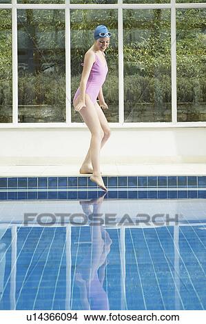 Woman dipping her toe into a pool. View Large Photo Image Picture - Woman dipping her toe into a pool.. Fotosearch