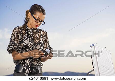 Stock Image - Woman working at home outdoors.. Fotosearch