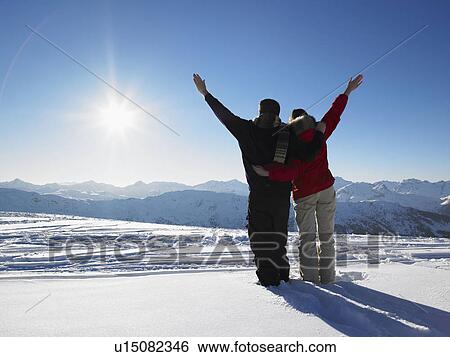 Stock Photograph - Couple admiring mountain view. Fotosearch