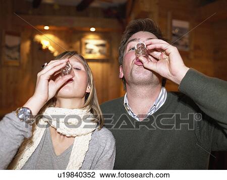 Couple having shots in restaurant View Large Photo Image Stock Image - Couple having shots in restaurant. Fotosearch