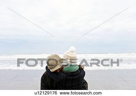 Stock Photograph - Couple hugging on beach. Fotosearch