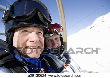 Couple on chair lift View Large Photo Image Picture - Couple on chair lift. Fotosearch