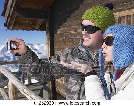 Couple taking photo of themselves View Large Photo Image Stock Image - Couple taking photo of themselves. Fotosearch