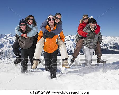 Couples piggyback in snow View Large Photo Image Stock Photo - Couples piggyback in snow. Fotosearch
