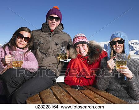 Picture - Group of friends having drink on terrace. Fotosearch