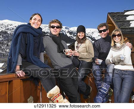 Stock Photography - Group of friends on terrace at mountains. Fotosearch