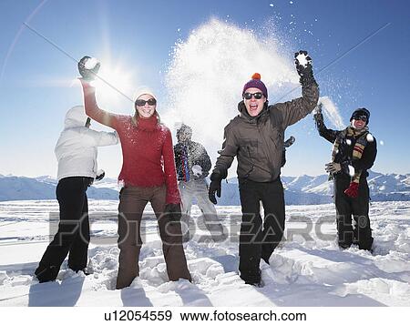 Group throwing snowballs View Large Photo Image Stock Photo - Group throwing snowballs. Fotosearch