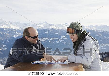 Man and young woman looking at map View Large Photo Image Stock Image - Man and young woman looking at map . Fotosearch