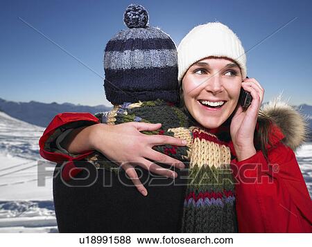 Man hugging woman on phone View Large Photo Image Stock Photo - Man hugging woman on phone. Fotosearch
