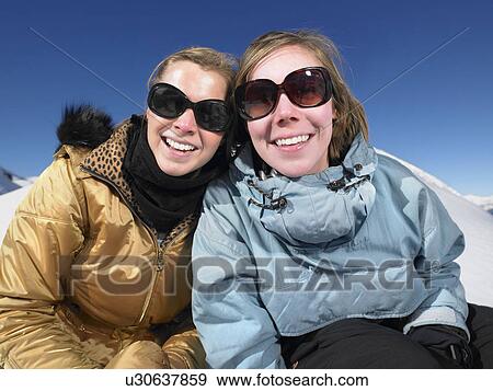 Stock Photo - Smiling young women in snow. Fotosearch