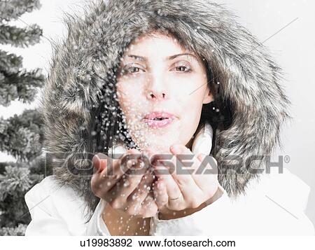 Woman next to a fir-tree, blowing snow View Large Photo Image Stock Image - Woman next to a fir-tree, blowing snow. Fotosearch