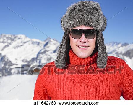 Young man in hat at mountains View Large Photo Image Stock Image - Young man in hat at mountains. Fotosearch