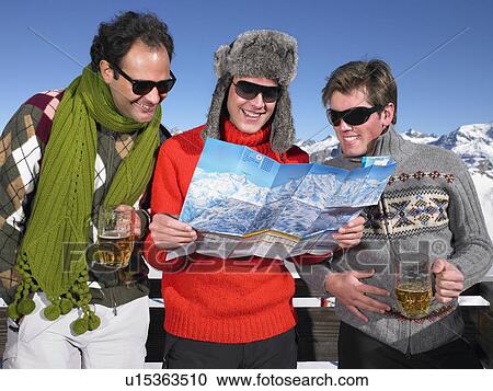Stock Image - Young men looking at map. Fotosearch