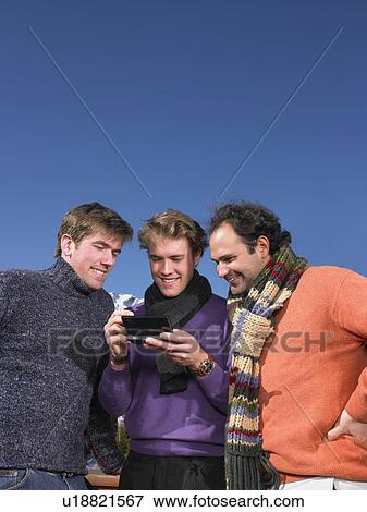 Young men playing video game on terrace View Large Photo Image Stock Photo - Young men playing video game on terrace. Fotosearch