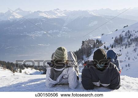 Stock Photograph - Young woman and man looking at view. Fotosearch