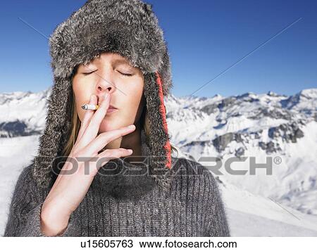 Young woman in hat smoking View Large Photo Image Stock Image - Young woman in hat smoking. Fotosearch