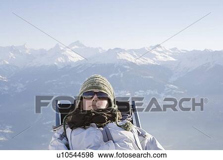 Stock Photo - Young woman relaxing in mountains. Fotosearch