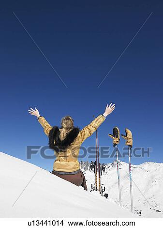 Picture - Young woman skier admiring mountain view. Fotosearch