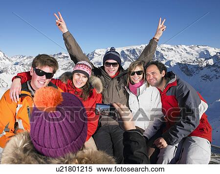 Young woman taking picture of group View Large Photo Image Stock Photography - Young woman taking picture of group. Fotosearch