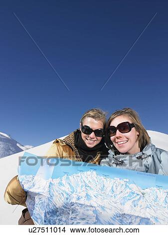 Picture - Young women looking at map. Fotosearch
