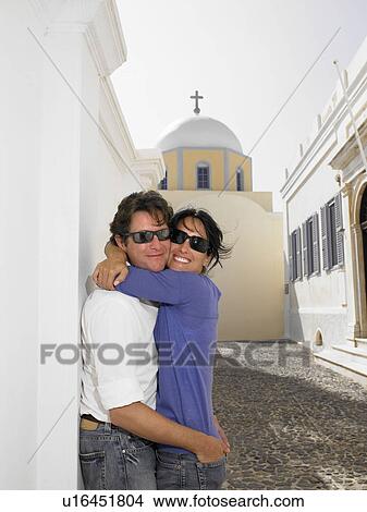 Picture - Couple hugging in the street. Fotosearch