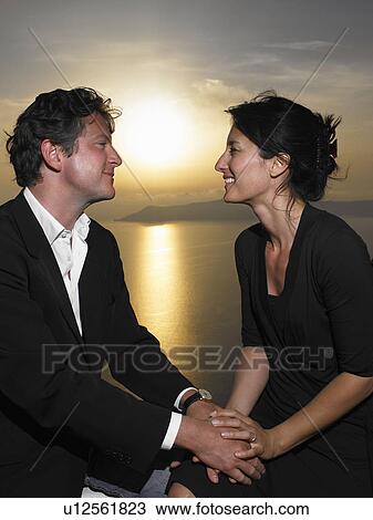 Couple looking at each other, sunset View Large Photo Image Stock Image - Couple looking at each other, sunset. Fotosearch