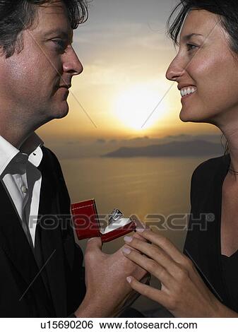 Man proposing to woman, sunset View Large Photo Image Stock Photograph - Man proposing to woman, sunset. Fotosearch
