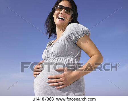 Stock Image - Pregnant woman smiling. Fotosearch