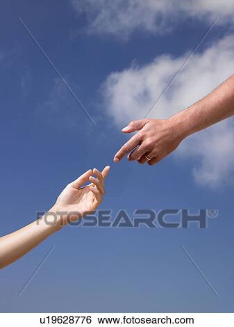 Stock Photograph - Two hands, almost touching each other. Fotosearch