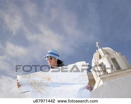 Stock Image - Woman looking at a map. Fotosearch