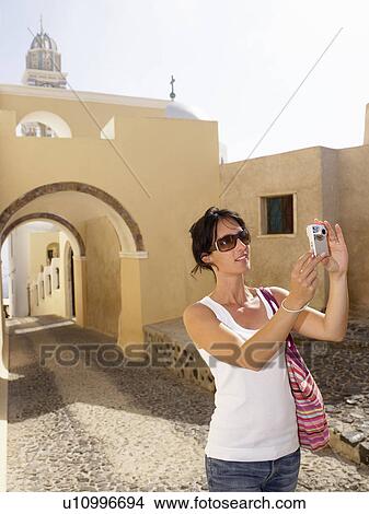 Picture - Woman taking pictures. Fotosearch