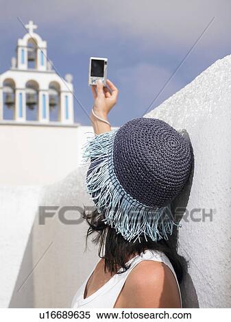 Stock Photography - Woman taking pictures. Fotosearch