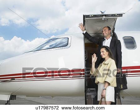 Couple exiting private jet while waving. View Large Photo Image Stock Image - Couple exiting private jet while waving.. Fotosearch