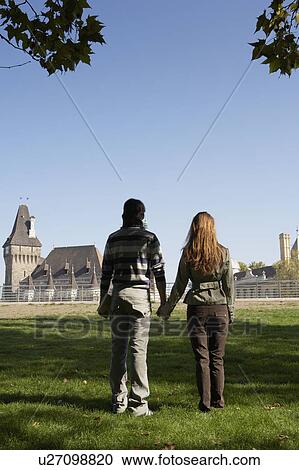 Couple holding hands in a park. View Large Photo Image Stock Image - Couple holding hands in a park.. Fotosearch