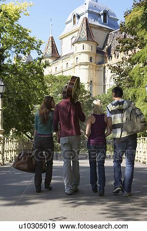 Four friends walking on a bridge. View Large Photo Image Stock Photo - Four friends walking on a bridge.. Fotosearch
