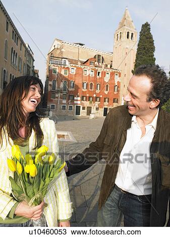 Italy, Venice, couple walking, woman holding flowers View Large Photo Image Stock Image - Italy, Venice, couple walking, woman holding flowers. Fotosearch