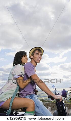 Stock Photography - Man and woman on scooter.. Fotosearch