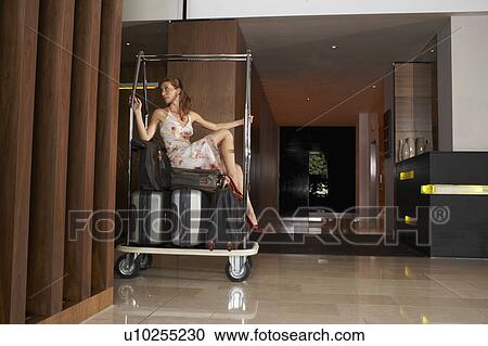 Woman on luggage trolley being pushed View Large Photo Image Stock Image - Woman on luggage trolley being pushed. Fotosearch