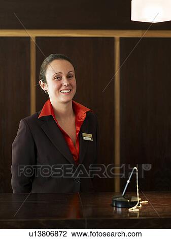 Young female hotel receptionist, smiling, portrait View Large Photo Image Stock Image - Young female hotel receptionist, smiling, portrait. Fotosearch