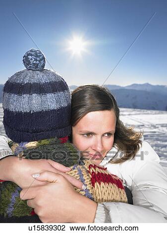 Stock Image - Couple hugging on mountain top. Fotosearch