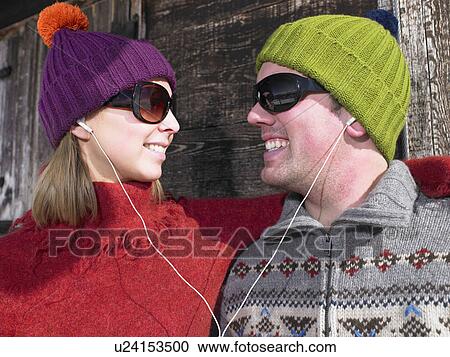 Couple listening to music at chalet View Large Photo Image Stock Image - Couple listening to music at chalet. Fotosearch