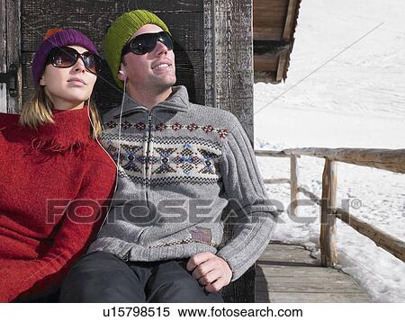Stock Photography - Couple listening to music at chalet. Fotosearch