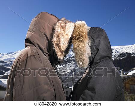 Stock Image - Couple listening to music at mountains. Fotosearch