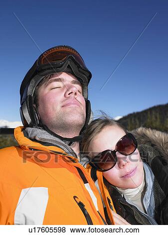 Stock Photo - Couple on ski lift. Fotosearch