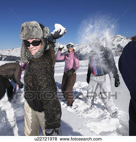 Stock Photo - Group throwing snowballs. Fotosearch