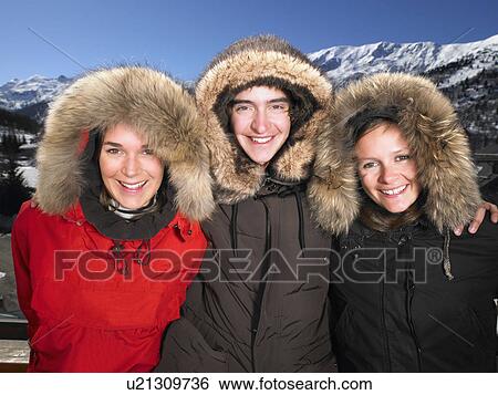 Stock Photograph - People wearing furry hooded jackets. Fotosearch
